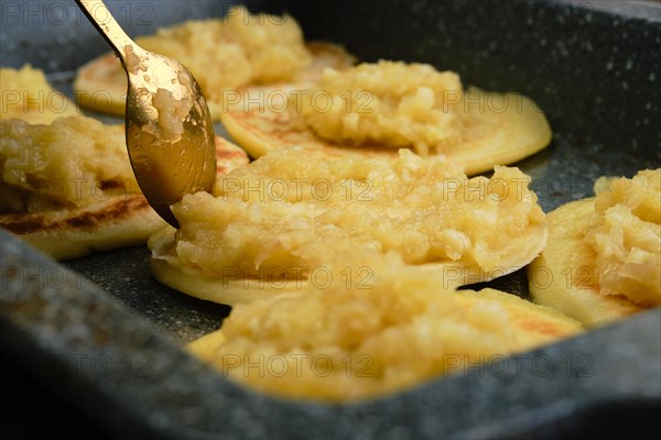 Closeup view of pancakes with caramelized apple and coconut cream