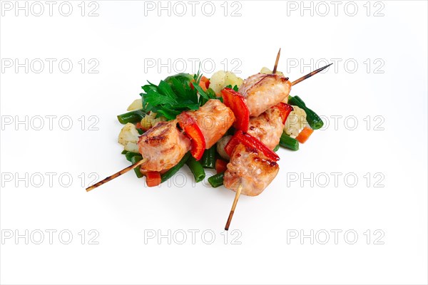 Shashlyk with roasted vegetables isolated on white