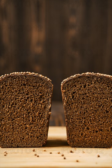 Closeup view of fresh rye brown bread on wooden cutting board