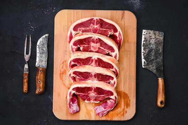 Fresh raw rack of lamb on wooden cutting board