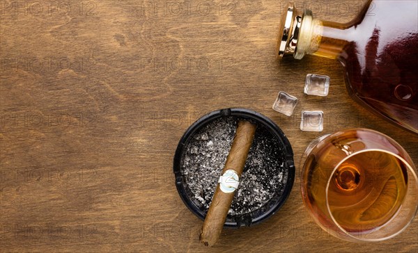 Flat lay cognac cigar with copy space
