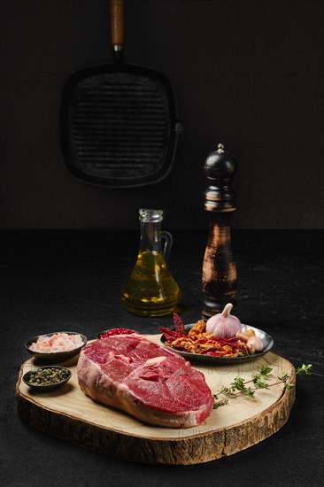 Raw fresh lamb center cut leg steak with spice on the kitchen table