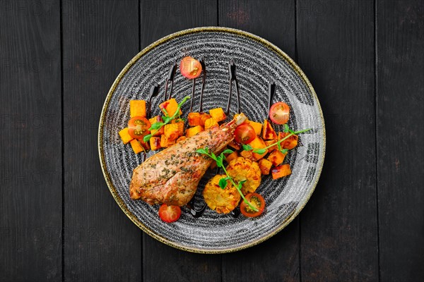 Top view of roaster turkey leg with fried pumpkin and grilled corn decorated with tomato