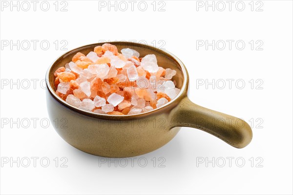 Pink Himalayan salt in a ceramic bowl isolated on white background