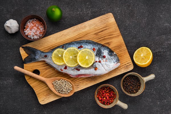 Overhead view of gilt head bream with spice prepared for cooking