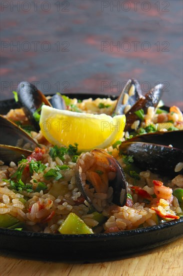 Selective focus photo of spanish paela with shrimps and mussels