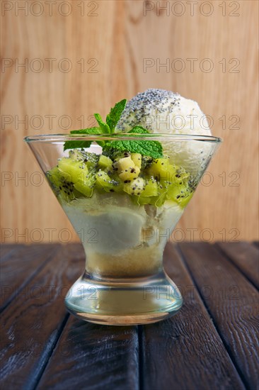 A cup of apple ice cream decorated with kiwi