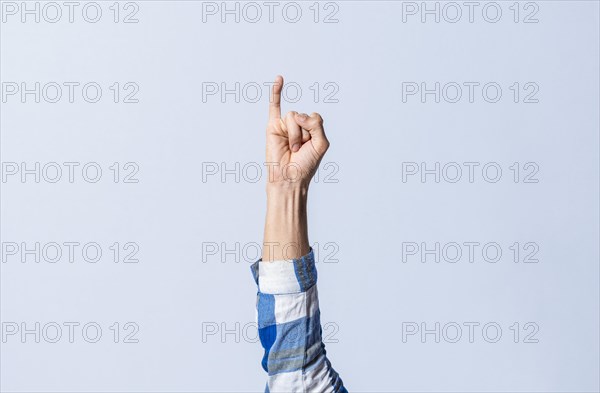 Hand gesturing the letter I in sign language on an isolated background. Man's hand gesturing the letter I of the alphabet isolated. Letters of the alphabet in sign language