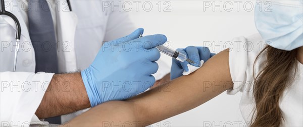 Little girl being vaccinated close up