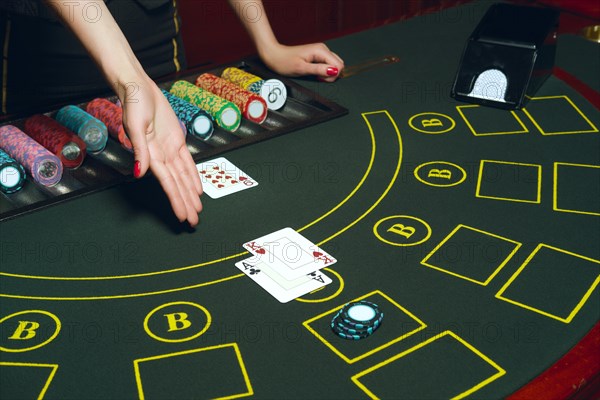 Casino poker table with chips and cards. Winning combination. Hand of Croupier open cards