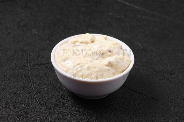 Small bowl with caesar sauce for salad