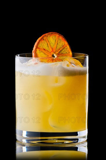 Variation of whiskey sour cocktail with orange syrup isolated on black background
