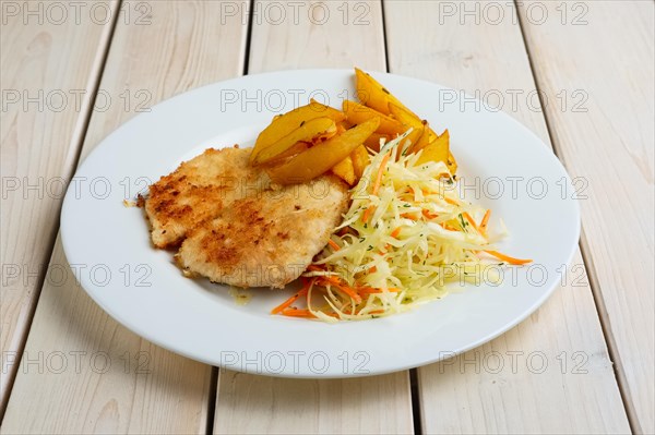 Chop cutlet with fried potato and fresh cabbage and carrot