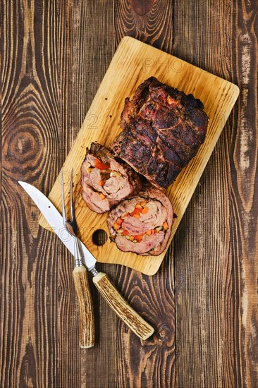 Overhead view of baked beef roll with vegetables