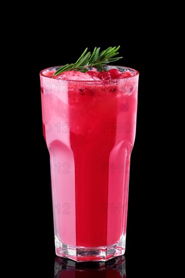 Glass of cranberry juice with crushed ice isolated on black background