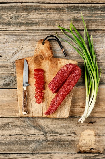 Top view of smoked dried turkey sausage on wooden cutting board