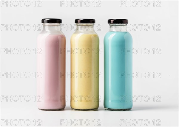 Front view three multicolored juice bottles