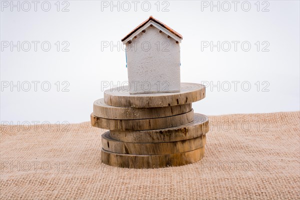 Little model house on a pieces of wooden logs