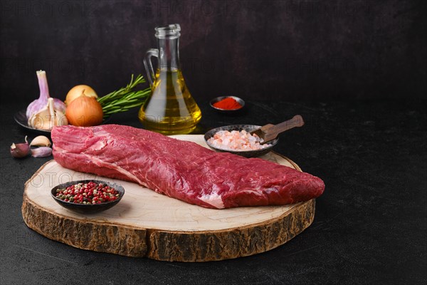 Overhead view of raw beef tri-tip roast with spice and seasoning ready for cooking