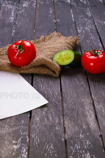 Fresh vegetables on wooden board with a napkin on a table
