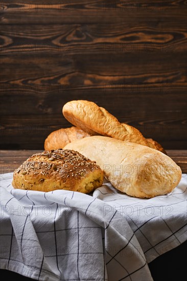 Assortment of cereal bread made of different seeds on wooden table