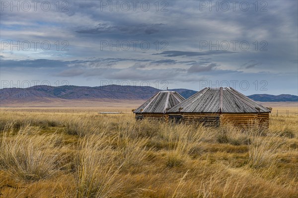 Wooden huts in Salbyksky Mound