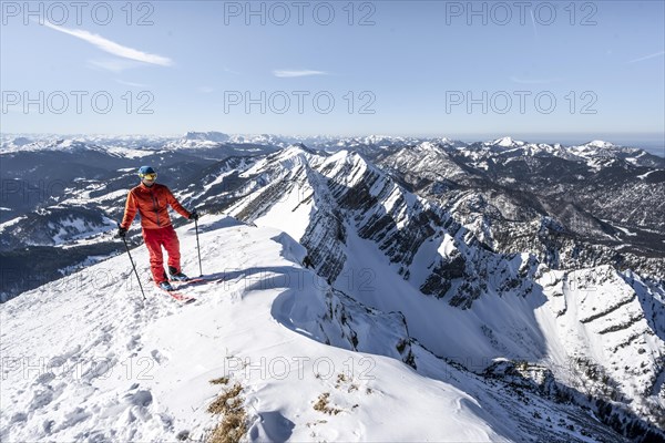 Ski tourers at the summit of Sonntagshorn in winter