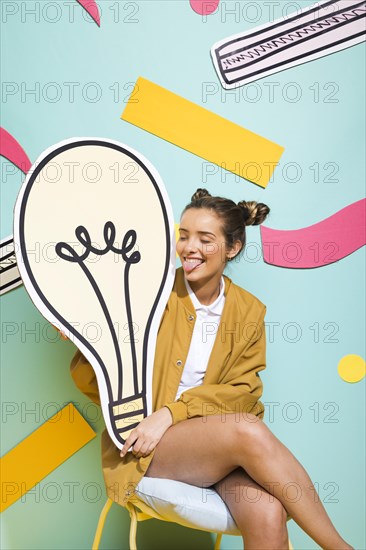 Portrait schoolgirl with big light bulb