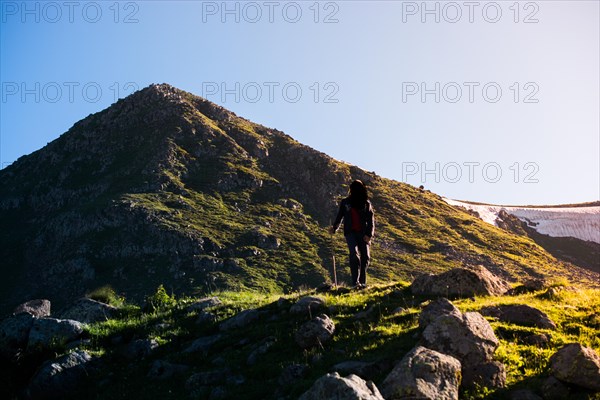 Hikers with backpacks and trekking poles walking in Turkish highland