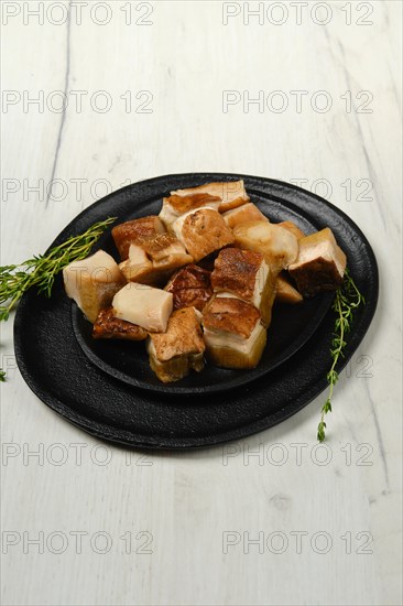 Frozen fresh boletus cut on pieces on black stone plate