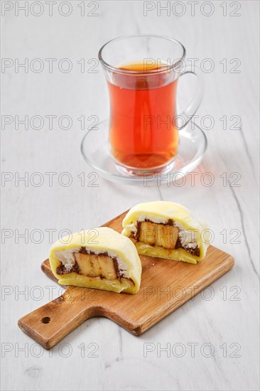 Sweet dessert mochi cut on half with fruit tea