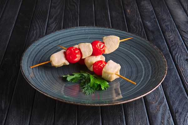 Appetizer for reception. Boiled chicken fillet and tomato cherry on skewer