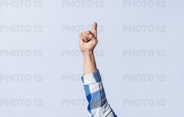 Hand gesturing the letter Z in sign language on an isolated background. Man's hand gesturing the letter Z of the alphabet isolated. Letter Z of the alphabet in sign language