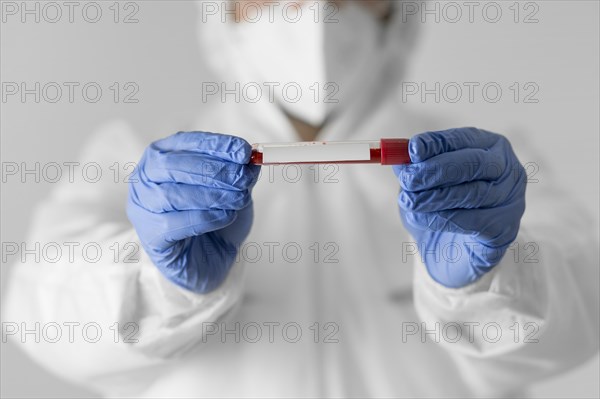 Close up doctor holding blood sample