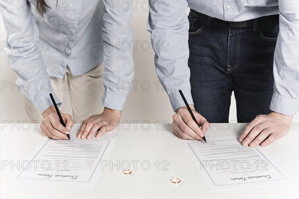 Couple signing divorce forms together