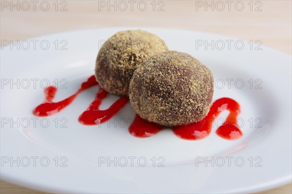 Chocolate truffles with biscuit powder. Rum balls and raspberry jam