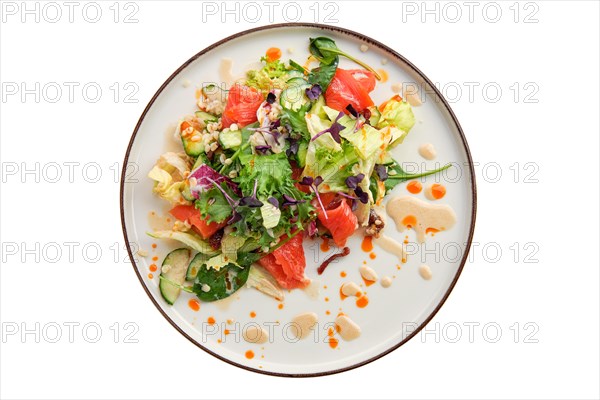 Salad with smoked salmon and fresh vegetables isolated on white background