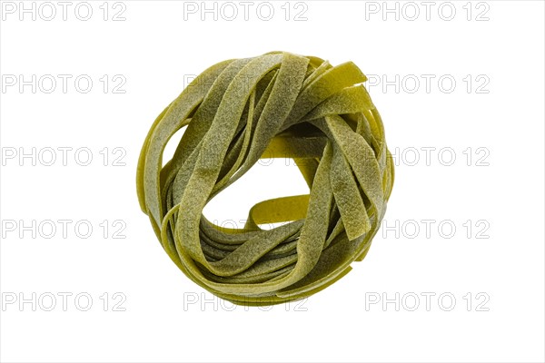 Top view of nest noodles isolated on white background. Italian tagliatelle with spinach