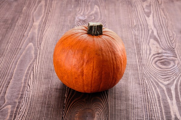 Small pumpkin on wooden board