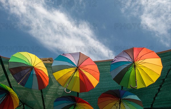 Hanging Colorful umbrellas urban street decoration under sky