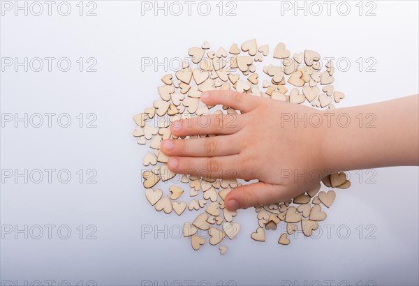 Retro style wooden hearts under hand as love concept
