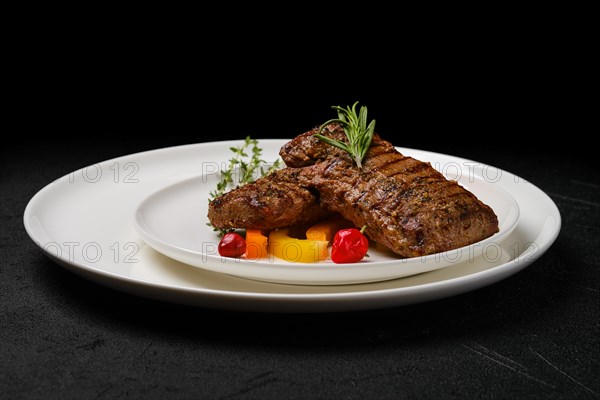 Two grilled steaks on a plate