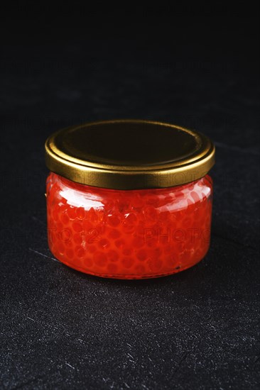 Jar with pink salmon red caviar