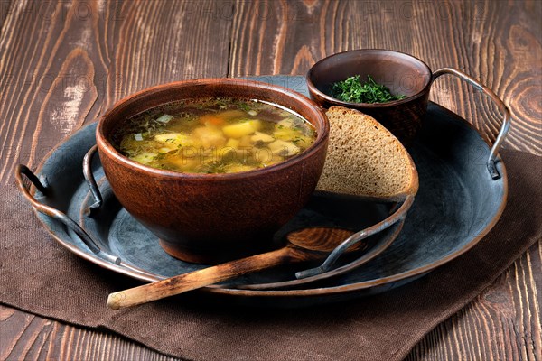 Rustic lunch with champignon soup on wooden table