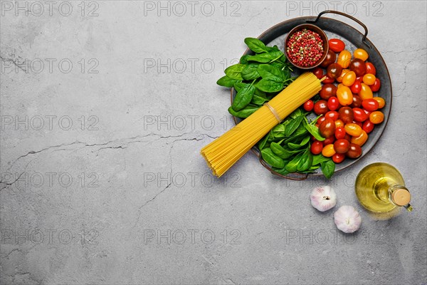 Overhead view of a bunch of raw spaghetti with spinach