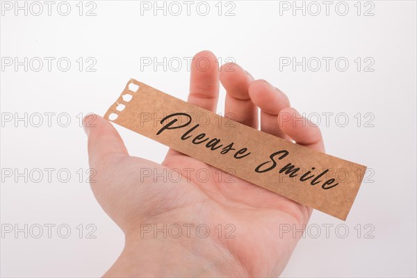 Please smile text on paper on a white background