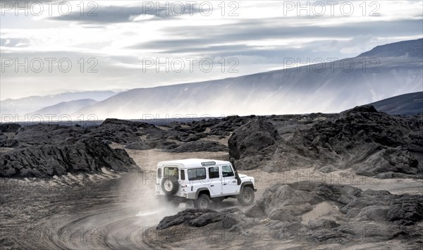 White Land Rover on a dirt road