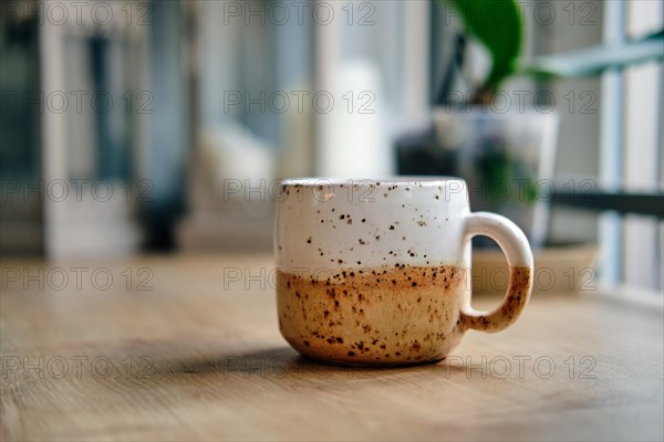 Scandinavian style ceramic cup on wooden table