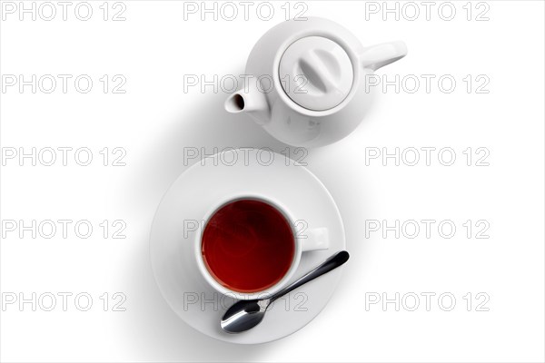 Ceramic tea cup and pot with Dilmah tea isolated on white