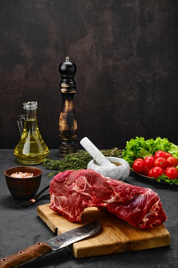 Overhead view of raw lamb rump on wooden cutting board